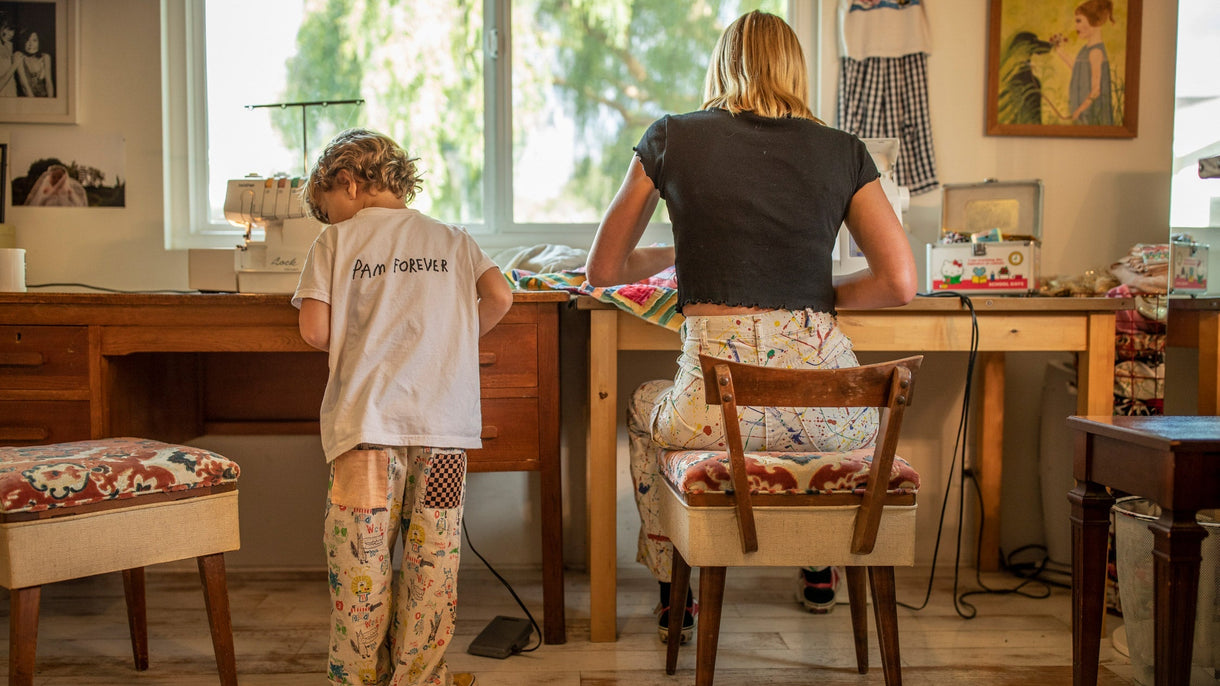 This family’s thread runs deep. Courtney Reynolds sews a quilt sourced from a local swap meet into a jacket for her twin girls while her son, Sammy, starts a project of his own on his kid-sized sewing machine. Photo: Tim Davis