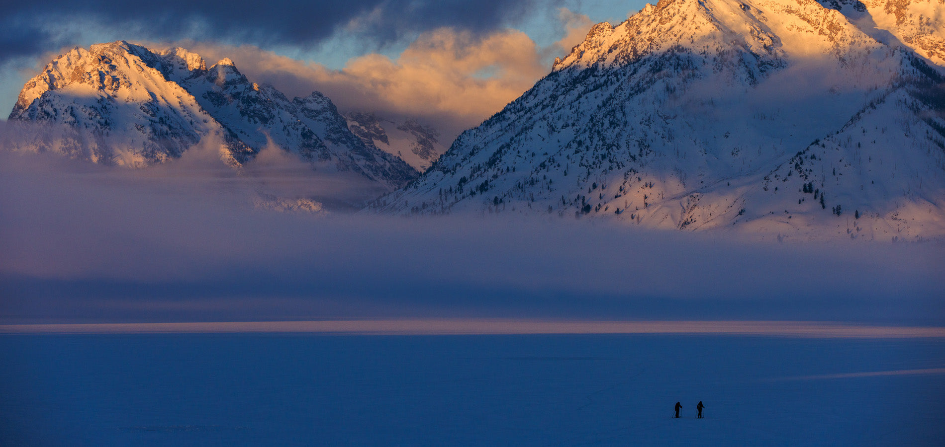 Emilé Zynobia and a friend skin across Jackson Lake to their objective. Grand Teton National Park, Wyoming.