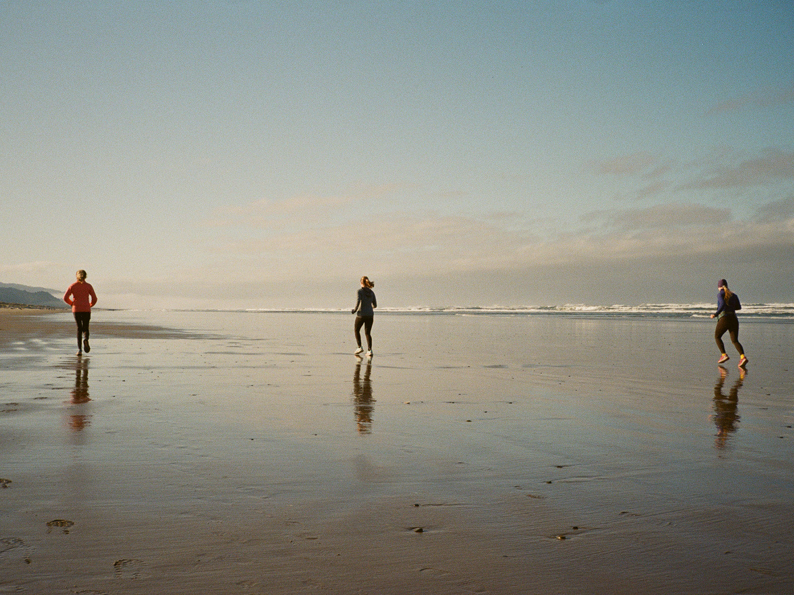 One of the best parts about running on the beach is having space to roam. From left to right, Barbara Mathews, Kyra Sweeney and Kiko Sweeney run in tandem across open beach at low tide near Manzanita, Oregon.