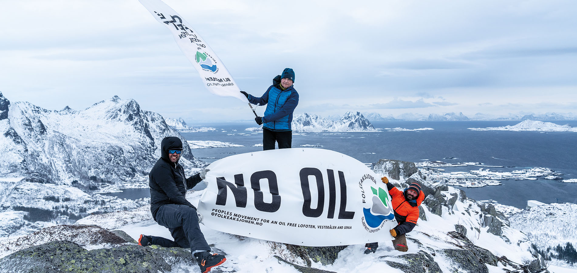 Seth Hobby (left), Odd Arne Sandberg (middle) and Espen Mortensen (right) fly the Folkeaksjonen flag loud and clear above Svolvær and Vestfjorden in Norway’s Lofoten archipelago.