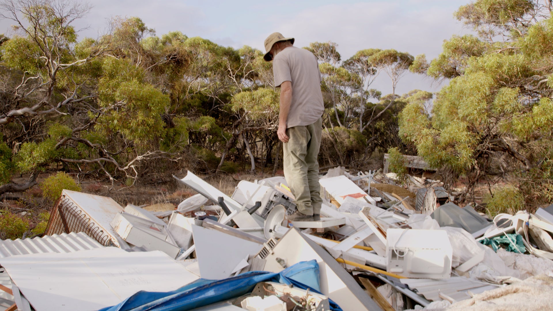 Opening image: Addy Jones standing on top of a ‘boneyard’ (rubbish dump) deep in the Australian bush, taken from Farm Boys episode one, ‘Junk Wizards’.