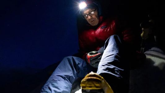 The glamorous work of a field-testing coordinator: Kelly Cordes making peace in a soaking wet jacket, at night, in the Rocky Mountains near his home in Estes Park, Colorado. Daniel Gambino