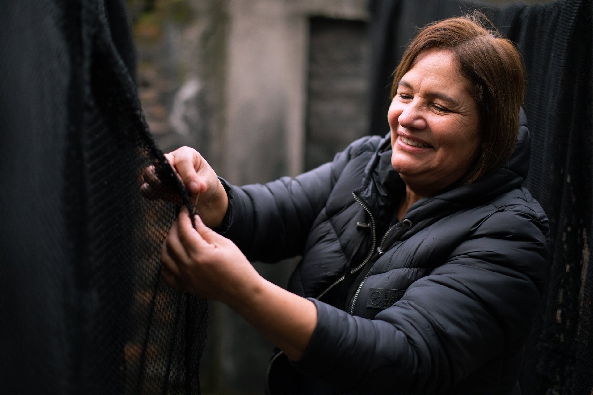 Jacqueline inspects nylon nets with a smile during the drying process at Bureo's warehouse in Talcahuano, Chile.