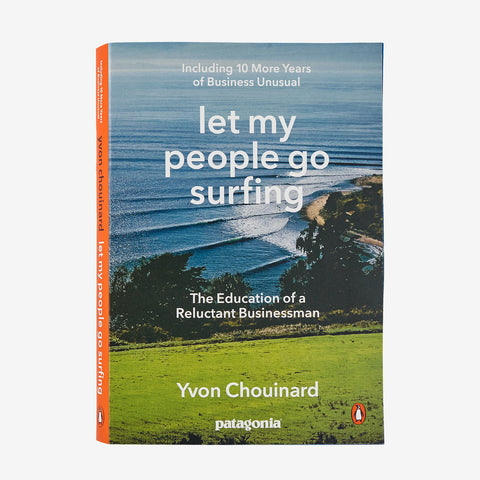 Let My People Go Surfing paperback book cover with aerial ocean coastline, green field, orange spine and Patagonia logo